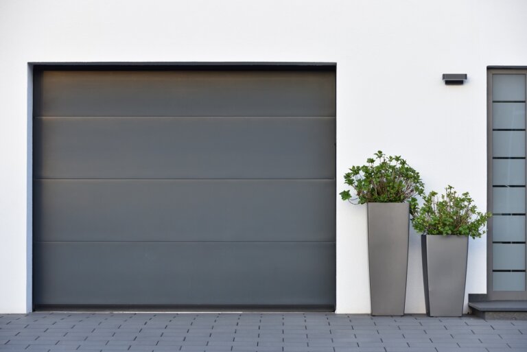 Modern gray garage, next to the Scandinavian-style house